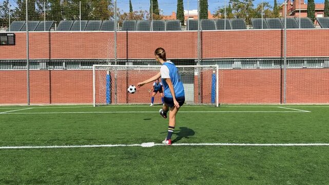 Female soccer player scoring a penalty kick goal