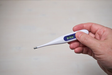 hand holding thermometer