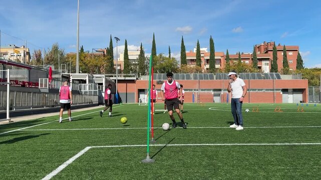 Young soccer player dribbling ball during training drill