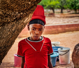 single african child in the village, carry buckets with water, water shortage in rural areas, climate change global warming