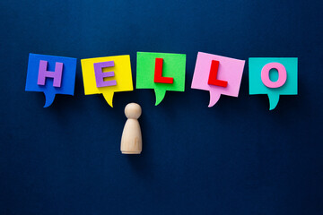 Wooden peg person with colorful hello speech bubbles