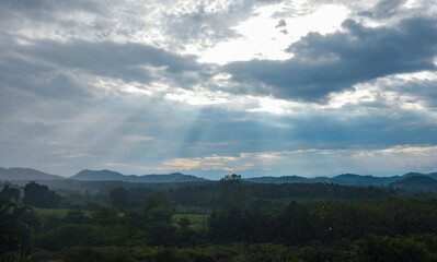 A photograph of the morning sky. Sunrise. Mountain landscape with mist surrounding the mountains.