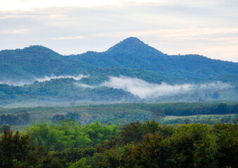 A photograph of the morning sky. Sunrise. Mountain landscape with mist surrounding the mountains.