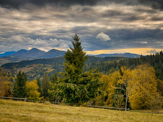 Sunny Autumn Carpathians with Puffy White During The Sunset