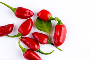 Vibrant red jalapeno pepper on a white background with space for text, ideal for food and culinary concepts.Group of ripe red jalapeno peppers .