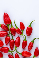 Vibrant red jalapeno pepper on a white background with space for text, ideal for food and culinary concepts.Group of ripe red jalapeno peppers .