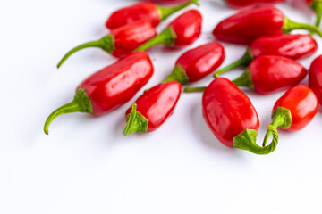 Vibrant red jalapeno pepper on a white background with space for text, ideal for food and culinary concepts.Group of ripe red jalapeno peppers .