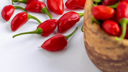 Vibrant red jalapeno pepper on a white background with space for text, ideal for food and culinary concepts.Group of ripe red jalapeno peppers .