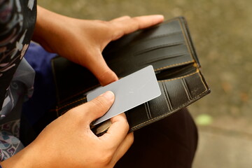 closeup women put the blank card in the wallet