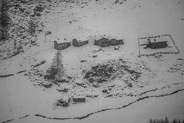 village huts in winter in snowfall
