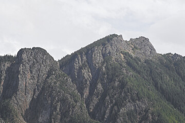 Rugged rocky peaks and forested slopes rise above Rattlesnake Ridge Trail, Washington, highlighting dramatic geology of the Pacific Northwest.