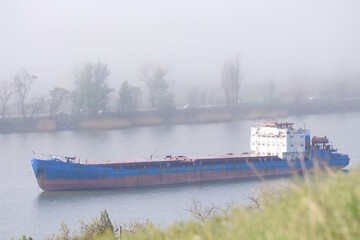 View of the Don river in the fog. The barge floats on the river.