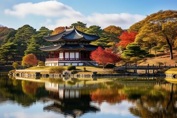 Fototapeta premium Traditional korean architecture reflected on the lake during a beautiful autumn day in hyangwonjeong garden, gyeongbokgung palace, seoul