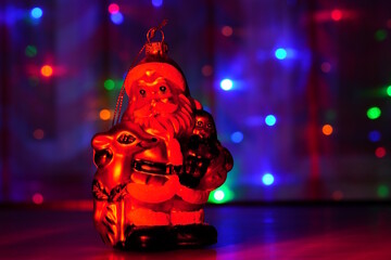 A Santa claus toy on a colored background.