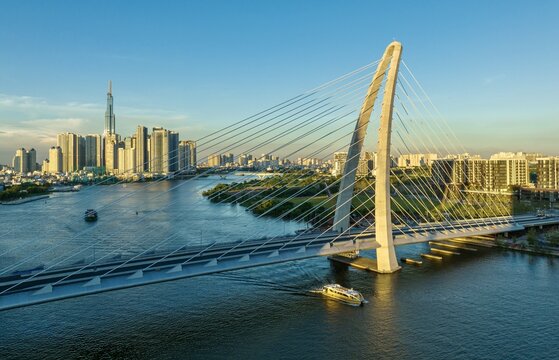 Aerial view of the Thu Thiem 2 Bridge elegantly spans the Saigon River, connecting the city skyline with its modern architecture, Ho Chi Minh City, Ho Chi Minh City, Vietnam.