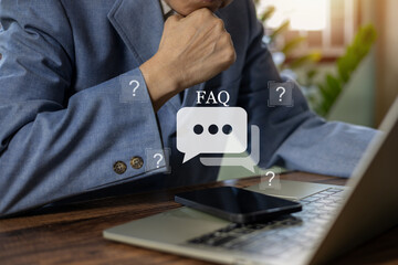 Businessman using phone with FAQ icon and question marks. Concept of customer support, online help center, finding answers, and solving problems in a digital business environment. Ask and consulting.