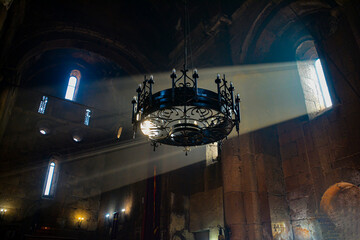 Monastery interior. An old lamp in the church. Sunlight streaming through the windows. Christianity and religion.