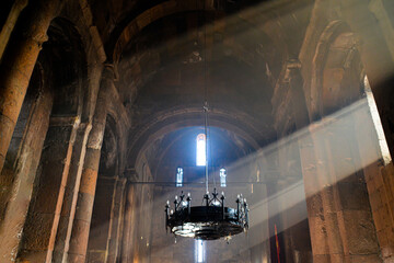 Monastery interior. An old lamp in the church. Sunlight streaming through the windows. Christianity and religion.