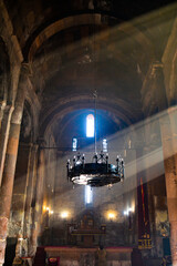 Monastery interior. An old lamp in the church. Sunlight streaming through the windows. Christianity and religion.