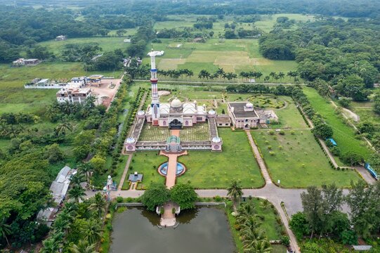 Aerial view of Baitul Aman Jame Masjid complex with its towering minaret rising amidst lush greenery, Barisal, Barisal Division, Bangladesh.