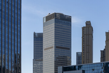 View of sleek, modern skyscrapers piercing the clear blue sky, a testament to urban design in Tianjin, Tianjin, China.