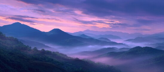 Misty mountain range under a vibrant purple and pink sky at dawn or dusk
