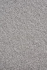 Fototapeta premium Clean white snow surface, top view. Vertical winter background with fresh snow texture and copy space.