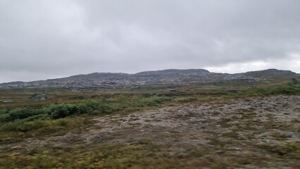 Obraz premium A road trip through Scandinavia is defined by vast forests, countless lakes, frequent rain, and a strong feeling of wilderness and solitude. The landscape is dominated by boreal forest, calm w