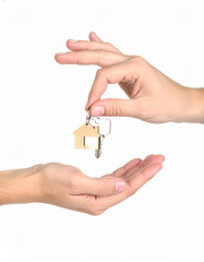 A professional real estate agent's hand giving new house keys to people for a successful property sale or mortgage business concept