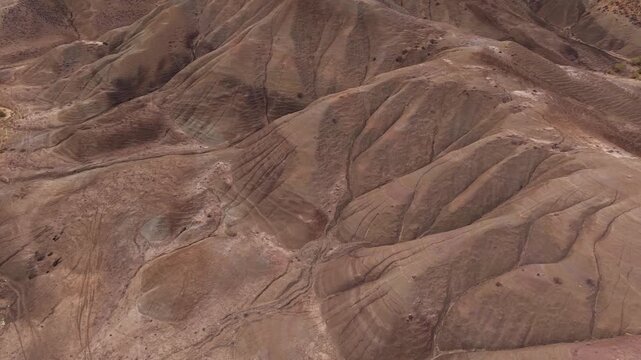 Aerial view of the arid Calanchi del Cannizzola landscape, revealing textures and patterns etched into the earth, Centuripe, Sicilia, Italy.