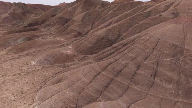 Aerial view of the Cannizzola's barren landscape presents a tapestry of earthy tones and textures, creating a stark yet captivating panorama, Centuripe, Sicilia, Italy.