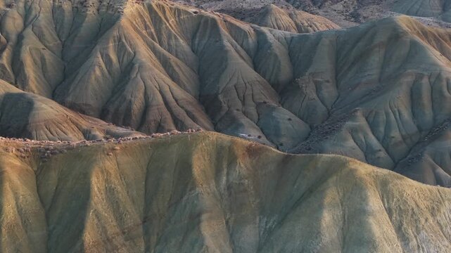 Aerial view of the Calanchi del Cannizzola, where the landscape is painted with varied earth tones and textures, showcasing nature's artistry, Italy.