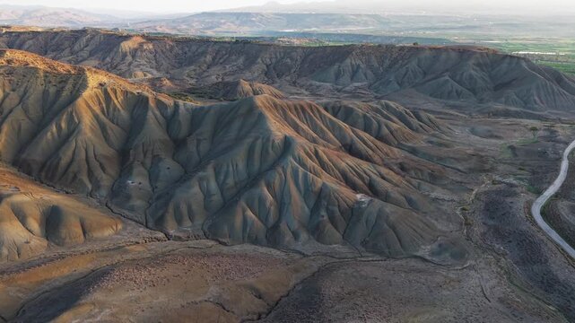 Aerial view of the textured Calanchi del Cannizzola hills, showcasing the landscape's unique geological formations, Calanchi del Cannizzola, Sicilia, Italy.
