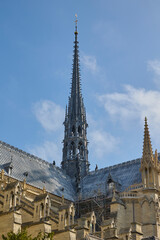 Spire of Notre Dame Cathedral during restoration under blue sky