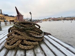 Naklejka premium fishing boats in the harbor in Stockholm, rope on the bridge