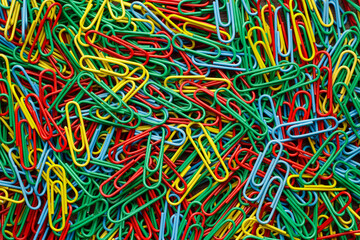 Flat lay photo of multicolored paper clips on the table.