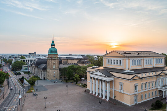Aerial view of a golden sunset casting a warm glow on the Hessische Landesmuseum Darmstadt and the column-lined facade of the Haus der Geschichte, Darmstadt, Hessen, Germany.