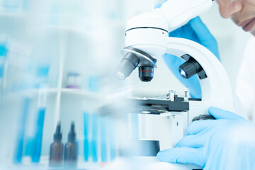 Scientist analyze biochemical samples in advanced scientific laboratory. Medical professional use microscope look microbiological developmental of viral. Biotechnology research in science lab.