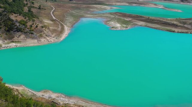 Turquoise lake shoreline and rugged landscape in Bosnia and Herzegovina