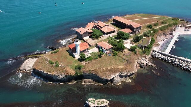 Aerial view of the historic St. Anastasia Island, showcasing its lighthouse and buildings surrounded by the turquoise waters of the Black Sea, St. Anastasia Island, Burgas, Bulgaria.