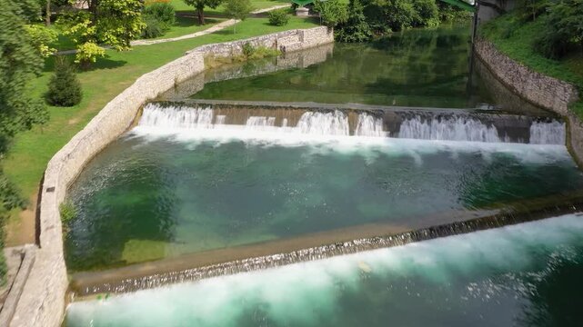 Clear green river flowing under stone bridge in Bosnia and Herzegovina