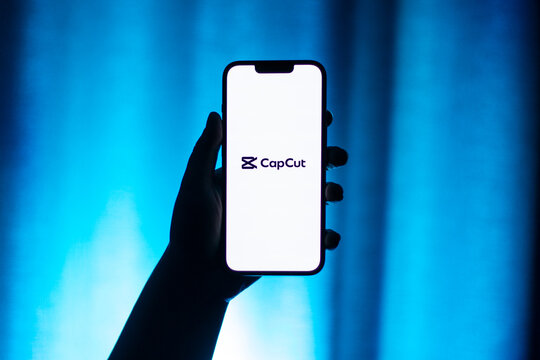 Kaliningrad, Russia - 12.11.2025. Smartphone screen in woman hands displaying logotype of popular application for video editing CapCut. Video edit app