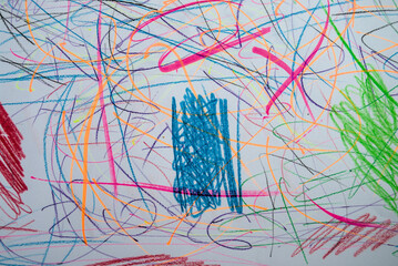 A paper covered with a chaotic mixture of blue, green and red scribbles.