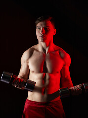 Young man training with dumbbells