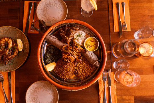 Directly above shot of traditional meal consisting of Injera flatbread with stew and vegetables on table in restaurant