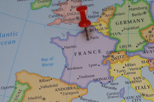 France country marked with red pushpin on Paris capital city. Europe map travel destination, French tourism and business location. Geographical navigation point. Political atlas macro close up view.
