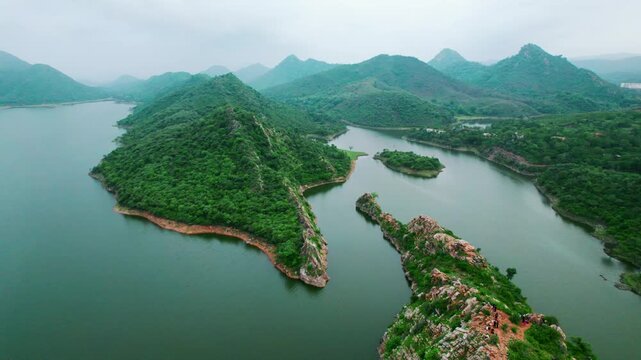 4K Aerial view of Badi lake between the mountains. Aerial view of Bahubali Hills at Udaipur, Rajasthan, India. Nature landscape. Tourist destination in Udaipur during monsoon season. Aravalli range ae