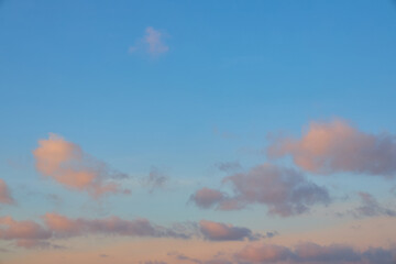 Beautiful blue sky with pink clouds at sunset.