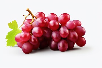 Fototapeta premium Ripe red grapes with a green leaf lying on a white background, creating a simple yet vibrant image