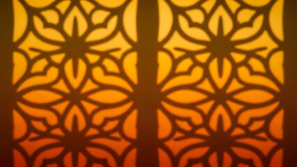Intricate Geometric Patterns Casting Warm Shadow Against a Soft Orange Gradient Background in an Elegant Decorative Window Design